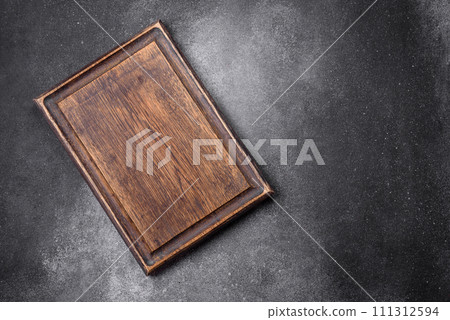 Empty wooden cutting board on a light texture background Empty wooden cutting board on a light texture background 111312594