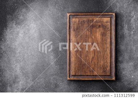Empty wooden cutting board on a light texture background 111312599