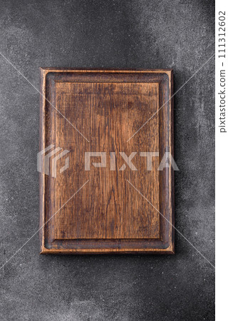 Empty wooden cutting board on a light texture background 111312602