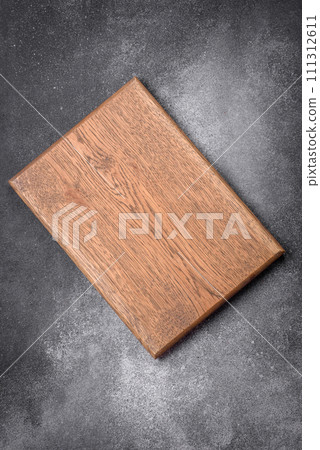 Empty wooden cutting board on a light texture background 111312611