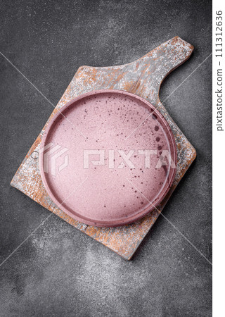 Empty round ceramic plate on a light texture background 111312636