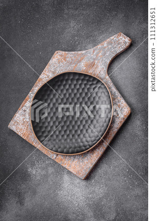 Empty round ceramic plate on a light texture background Empty round ceramic plate on a light texture background 111312651