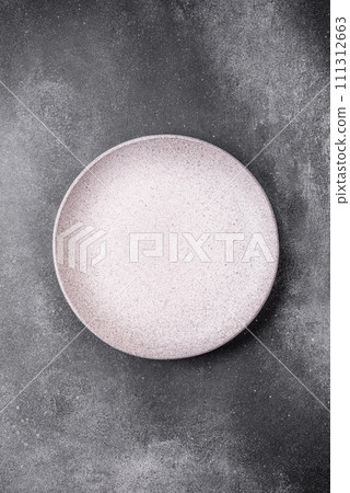 Empty round ceramic plate on a light texture background 111312663