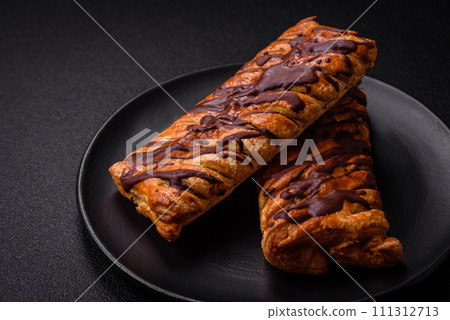 Delicious crispy sweet puff pastry with chocolate and salted caramel Delicious crispy sweet puff pastry with chocolate and salted caramel 111312713