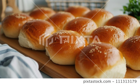 Freshly Baked Dinner Rolls on Wooden Board 111313179