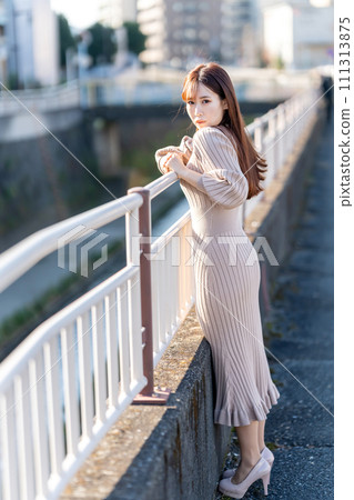 young woman in knitted dress 111313875
