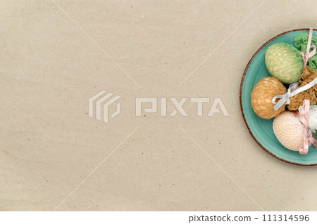 Easter eggs on a plate with craft paper background Easter eggs on a plate with craft paper background 111314596