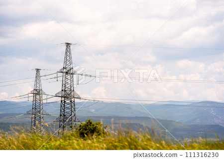 High voltage towers Electric pole. Power line support with wires for electricity transmission. High voltage grid tower with wire cable at distribution station. Energy industry, energy saving High voltage towers Electric pole. Power line support with wires for electricity transmission. High voltage grid tower with wire cable at distribution station. Energy industry, energy saving 111316230