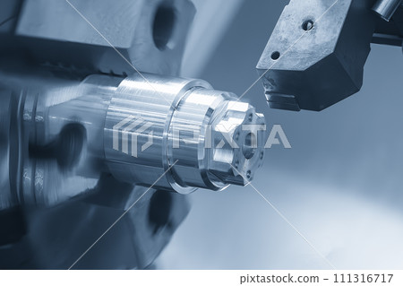 The  CNC lathe machine forming  cutting the metal shaft parts. 111316717