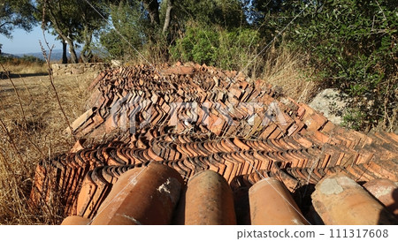 Hundreds of antique roof tiles ready to be used for a new home. 111317608