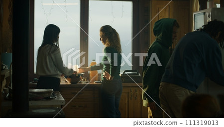 Man comes in kitchen and looks in fridge Man comes in kitchen and looks in fridge 111319013