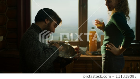 Romantic couple talk and cook breakfast in wooden house 111319095