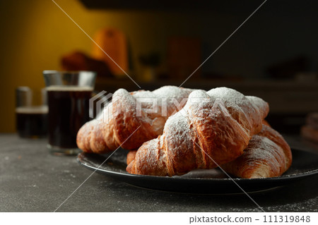 Croissants sprinkled with sugar powder. 111319848