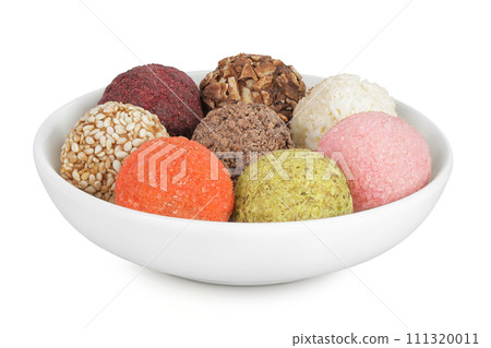 A variety of different truffles in a ceramic bowl Isolated on a white background A variety of different truffles in a ceramic bowl Isolated on a white background 111320011