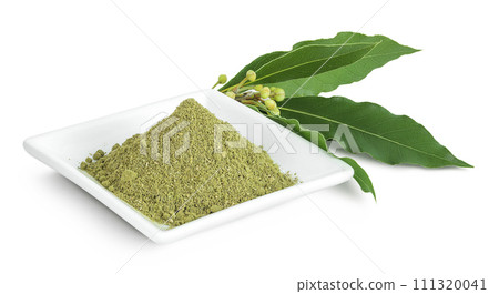 Fresh and ground Laurel leaves in ceramic bowl isolated on white background. Green bay leaf 111320041