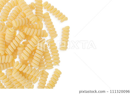 Italian spiral shaped pasta, Fusilli bucati macaroni, isolated on white background. Top view with copy space for your text. Flat lay. Italian spiral shaped pasta, Fusilli bucati macaroni, isolated on white background. Top view with copy space for your text. Flat lay. 111320096