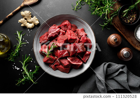 Beef meat entrecote sliced, raw beef meat fillet on black background, top view Beef meat entrecote sliced, raw beef meat fillet on black background, top view 111320528