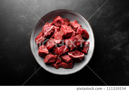 Beef meat entrecote sliced, raw beef meat fillet on black background, top view 111320534