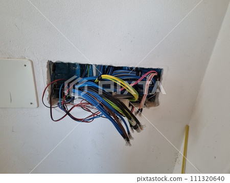 A Bunch Of Wires Are Coming Out Of A Hole In A Wall A Bunch Of Wires Are Coming Out Of A Hole In A Wall 111320640
