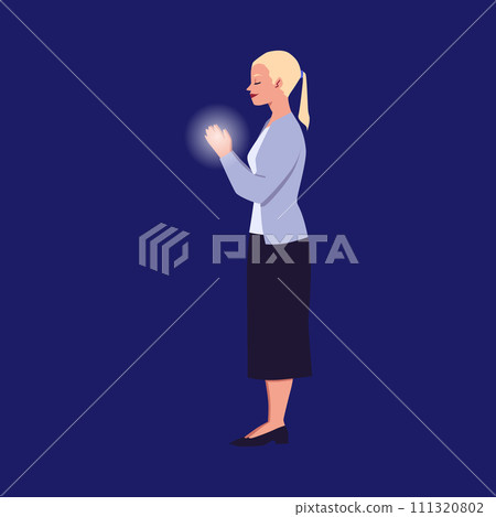 Young woman stand and praying with folded hands and closed eyes 111320802