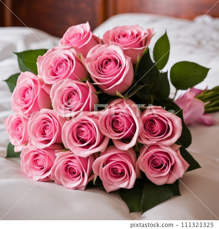 Bouquet of Pink roses on the bed in a hotel room for honeymoon. romantic meeting of guests at the hotel 111321325