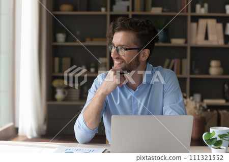 Pensive smiling businessman distracted from computer work look into distance Pensive smiling businessman distracted from computer work look into distance 111321552