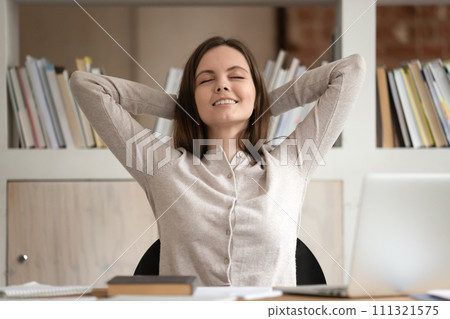 Happy female student relax in chair with eyes closed Happy female student relax in chair with eyes closed 111321575