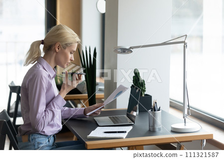 Young woman consult client on smartphone loudspeaker 111321587