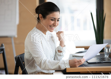 Overjoyed indian female employee triumph reading letter 111321678