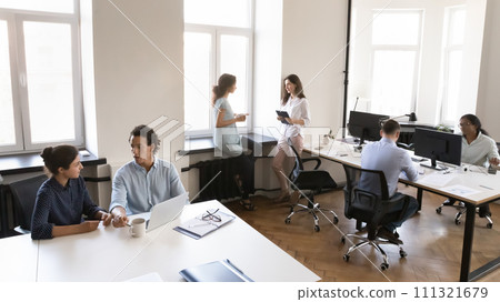 Multiethnic business team working in small office space 111321679