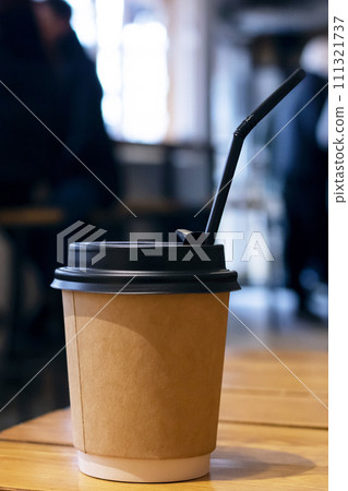 Paper coffee cup on table in cafe Paper coffee cup on table in cafe 111321737