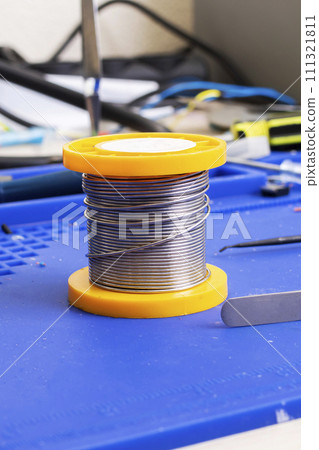 Solder coil on silicone soldering mat closeup 111321811
