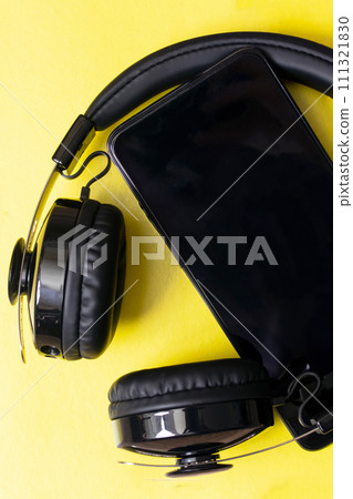 Headphones and phone on a yellow background Headphones and phone on a yellow background 111321830