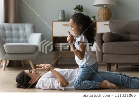 Little Indian girl play patty cake with young mother Little Indian girl play patty cake with young mother 111321860