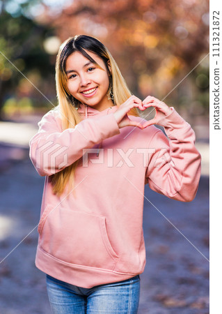 Peruvian young latin woman Portrait, love heart shape for valentine or InspireInclusion gesture 111321872