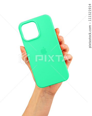 Berlin Germany December 21 2023 Green phone case in hand. Silicone protector isolated on white Berlin Germany December 21 2023 Green phone case in hand. Silicone protector isolated on white 111321914