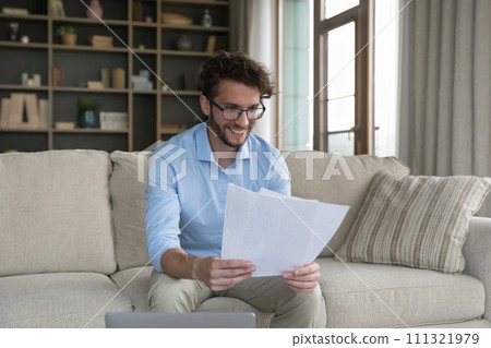 Happy man read received notification from bank with good news Happy man read received notification from bank with good news 111321979