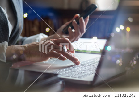 Businesswoman working in office on cell phone and laptop. Businesswoman working in office on cell phone and laptop. 111322242
