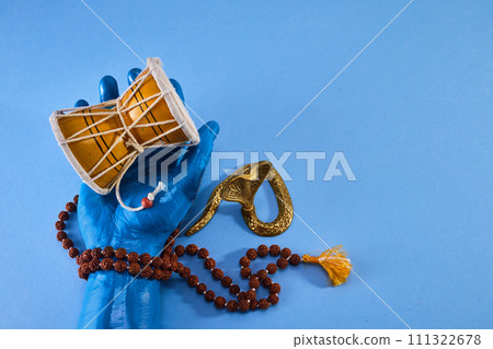 Shivaratri background with Shiva hand and Drum Damroo musical instrument. Maha Shivratri festval. 111322678