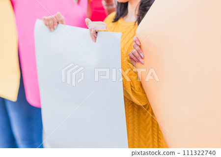 Protest march or strike holding blank board outdoors. Activist social and feminism rights.  111322740