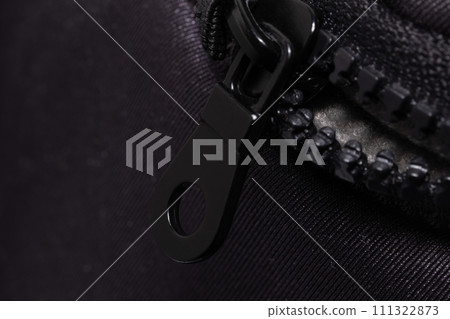 Close-Up View of a Black Zipper on a Textured Fabric Surface Close-Up View of a Black Zipper on a Textured Fabric Surface 111322873