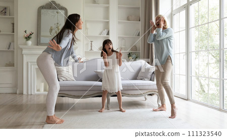 Little girl with mother and grandmother dancing at home Little girl with mother and grandmother dancing at home 111323540