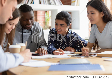 Multiethnic students work on group project in classroom 111323542