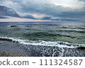 The approaching shower in rainy weather over the sea. 111324587