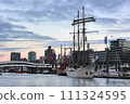 Hamburg, Germany - December 12, 2009: View to downtown and harbour with moored tourist ship Mare Frisium in Hamburg. 111324595
