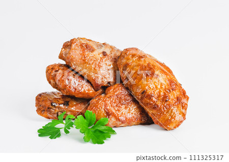 Chicken wings fried until half cooked, semi-finished product with fresh herbs on a white background. Fast food. Quick cooking at home. Copy space.Fast cooking.Fast homemade food. Chicken wings fried until half cooked, semi-finished product with fresh herbs on a white background. Fast food. Quick cooking at home. Copy space.Fast cooking.Fast homemade food. 111325317