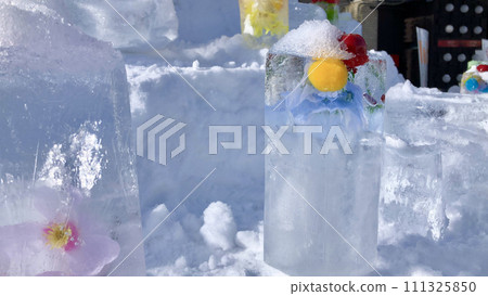 Ice sculpture with artificial flowers 111325850