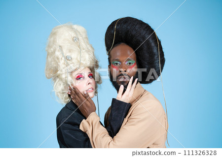 Gay couple with vintage wigs and makeup in blue 111326328