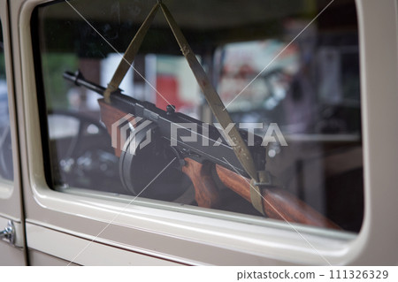 Closeup of RPD machine gun hanging inside car 111326329