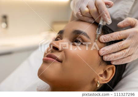 Smiling woman on a mesotherapy treatment session Smiling woman on a mesotherapy treatment session 111327296